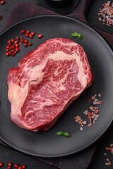 Fresh juicy raw beef striploin steak with salt and spices