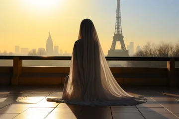 Fotobehang Elegant veiled woman on Paris rooftops at sunrise with Eiffel Tower view. © XaMaps