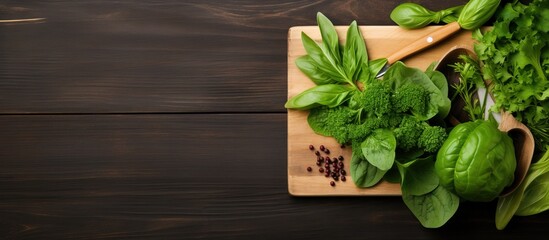 Front view composition of fresh green leafy vegetables and kitchen utensils on wooden countertop with space for display