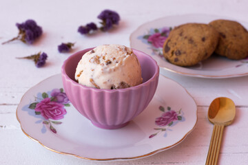 Vanilla ice cream and cookies in a pink bowl