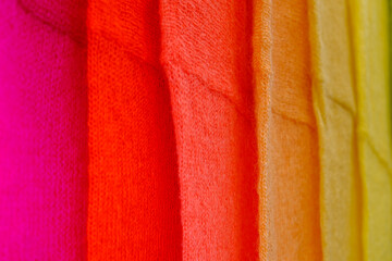 Assorted colors of woolen knitted off the shoulder clothes at the market of clothing homemakers....