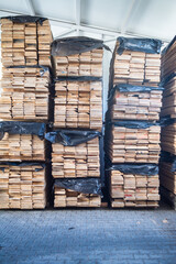 stacked pallets in warehouse. Wood industry