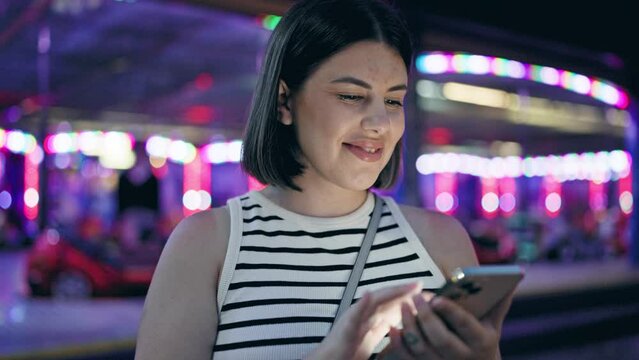 Young beautiful hispanic woman smiling happy using smartphone at Prater Vienna