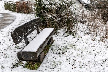The benches covered with snow