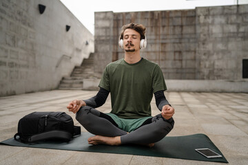one man doing guided meditation online yoga self care concept outdoor