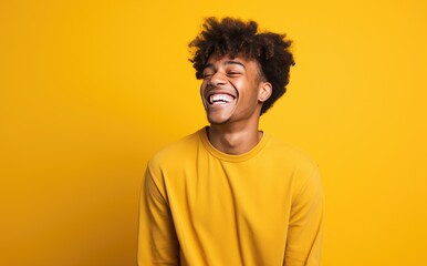 Fototapeta na wymiar Photo of young male smiling and laughing on bright yellow background