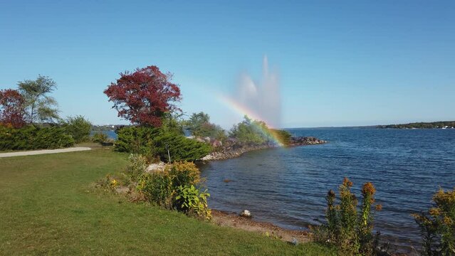 Rainbow from the spray of a fountain on the shore of the lake Simcoe in Barrie, Ontario, Canada.