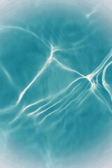 Defocus blurred transparent blue colored clear calm water surface texture with splashes reflection. Trendy abstract nature background. Water waves in sunlight with copy space. Blue watercolor shine.