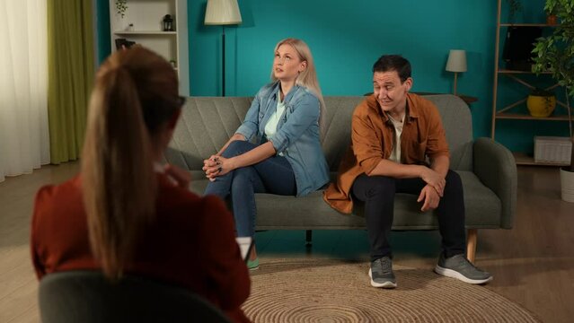 A visit to a family psychologist for a married couple. A man talks indignantly about problems in his relationship while sitting next to a woman who ignores him. Crisis of relationships in family life.