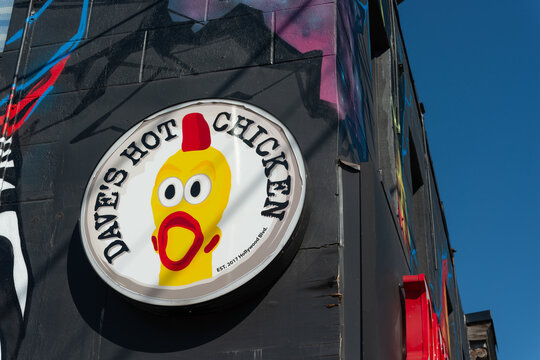 exterior sign of Dave's Hot Chicken chain chicken restaurant located at 1582 Queen Street West, Toronto, Ontario