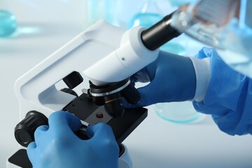 Scientist working with microscope at table, closeup. Medical research