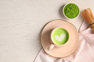 Flat lay composition with tasty matcha latte on white wooden table, space for text