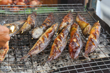 fresh grilled fish is being prepared on the street in Vietnam
