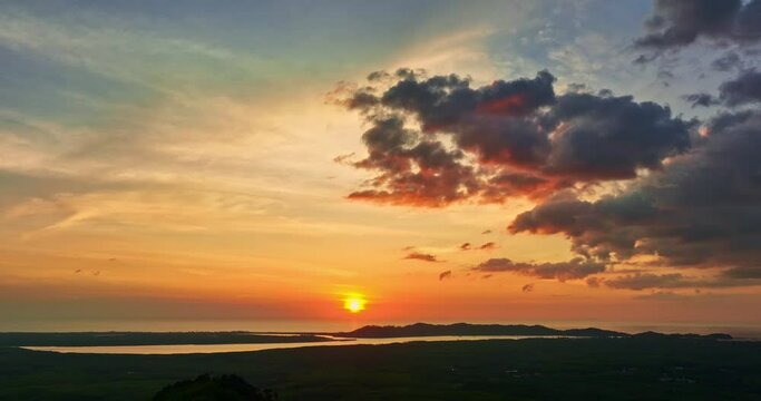 .There is a golden yellow glow on the horizon caused by the radiant light of the sun..colorful sky of sunset sunrise 4K Shooting with Drone. Gradient color..clouds move over the sea in golden sunset
