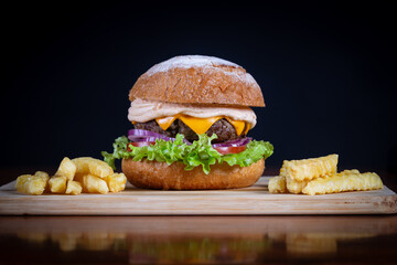Beef burger with lettuce, tomato, cheddar cheese and onion