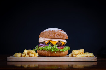 Beef burger with lettuce, tomato, cheddar cheese and onion