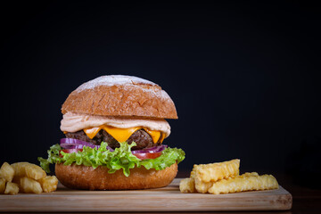 Beef burger with lettuce, tomato, cheddar cheese and onion