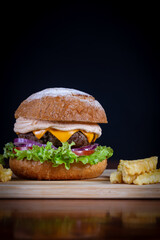 Beef burger with lettuce, tomato, cheddar cheese and onion