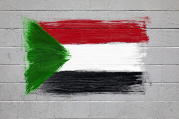 Sudan flag colors painted on brick wall