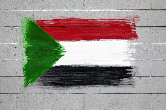 Sudan flag colors painted on brick wall