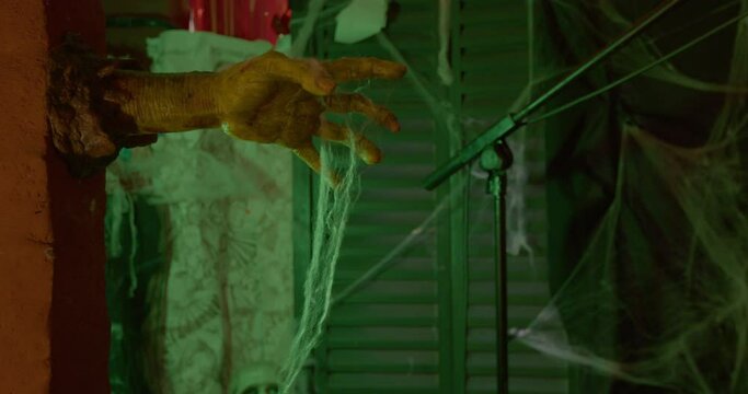 Artificial creepy yellow zombie hand coming out of the wall, decor