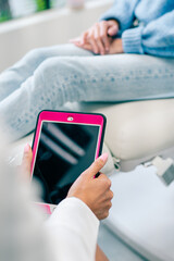 Close up of doctor using a digital tablet next to patient