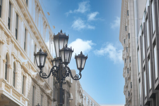 Elegant street lamp surrounded bu buildings 