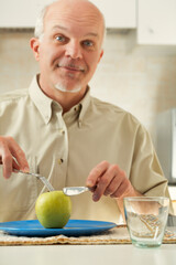 Fototapeta premium Elder with apple, yearns for indulgent meals