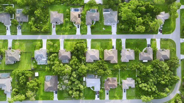 Aerial landscape view of suburban private houses between green palm trees in Florida quiet rural area