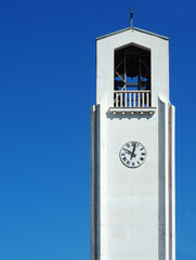 clock tower on St. Mary's Assumption Church in the town of Bibinje , Croatia against clear blue sky...