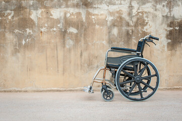 Old, empty wheelchairs as vintage transportation in a park, hospital, or street