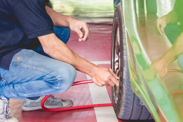 Filling air into a car tire at service center