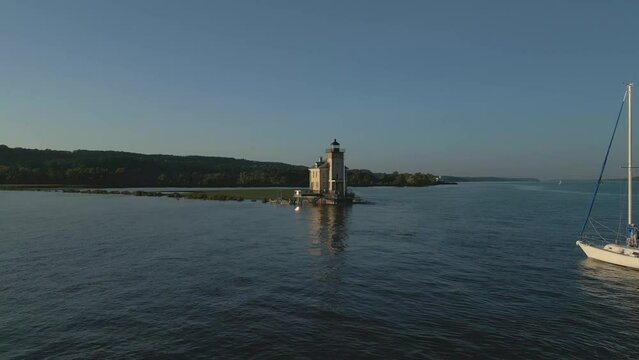 Aerial view of old lighthouse at sunset, drone 4K