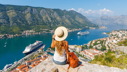 Woman tourist enjoying panoramic view of Kotor Bay- travel, tour tourism, vacation in Montenegro, Europe - obrazy, fototapety, plakaty