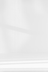 Empty white desk with morning light and shadows of windows with copy space, summer concert. Blurred backdrop abstract background for display product.