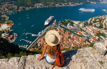 Traveler young female looking at panoramic view of Kotor Bay- travel, tour tourism, vacation in Montenegro, Europe