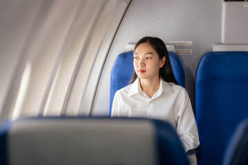 Thoughtful asian people female person onboard, looking out of airplane window, perfectly capture the anticipation and excitement of holiday travel. chinese, japanese people.