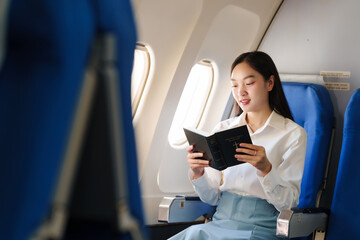 Reading a book, Thoughtful asian people female person onboard, airplane window, perfectly capture...