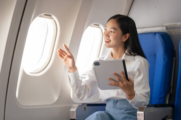 Using tablet pc, Thoughtful asian people female person onboard, airplane window, perfectly capture...
