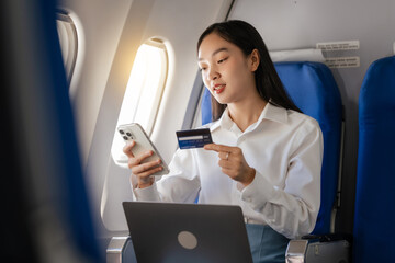 Using mobile and credit card, cashless payment, Thoughtful asian people female person onboard,...