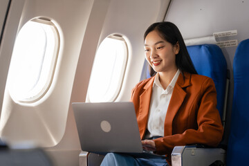 using laptop computer, Elegantly dressed brown suit Asian chinese japanese people businesswoman...