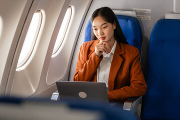 using laptop computer, Elegantly dressed brown suit Asian chinese japanese people businesswoman...