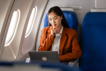 using laptop computer, Elegantly dressed brown suit Asian chinese japanese people businesswoman...