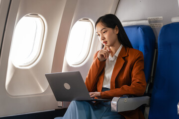 using laptop computer, Elegantly dressed brown suit Asian chinese japanese people businesswoman...