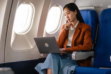 using laptop computer, Elegantly dressed brown suit Asian chinese japanese people businesswoman...