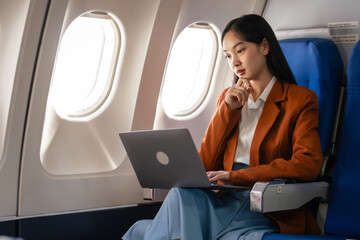 using laptop computer, Elegantly dressed brown suit Asian chinese japanese people businesswoman...