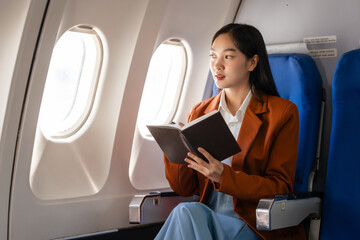 using note book, Elegantly dressed brown suit Asian chinese japanese people businesswoman immersed...
