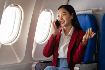 Passionate female asian chinese japanese people student aboard airplane, clutching textbooks, eagerly anticipating her overseas academic venture.