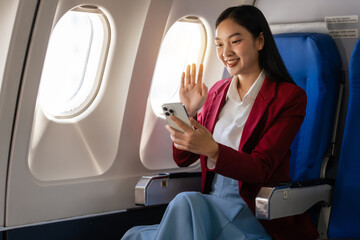 Passionate female asian chinese japanese people student aboard airplane, clutching textbooks, eagerly anticipating her overseas academic venture.