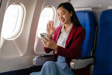 Passionate female asian chinese japanese people student aboard airplane, clutching textbooks, eagerly anticipating her overseas academic venture.